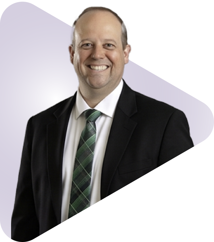Smiling leader in a black suit and green plaid tie