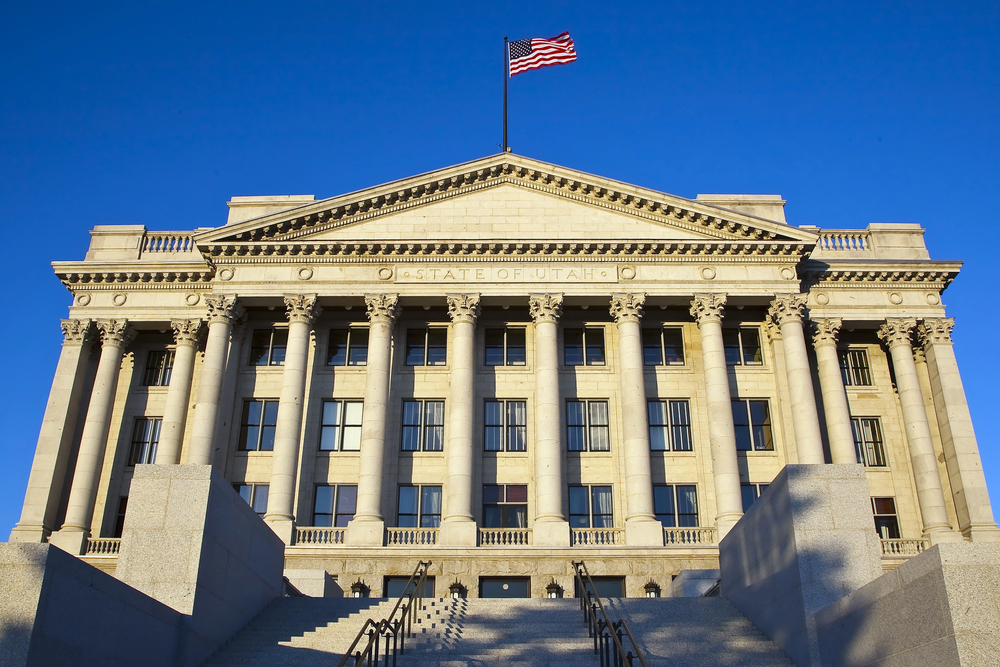 A state capitol building with an American flag flying above it